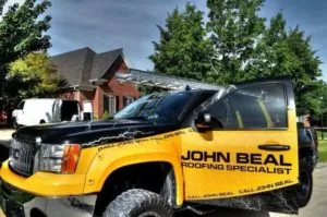 John Beal Roofing service truck parked outside a home — John Beal Roofing